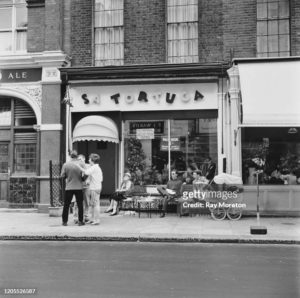 Patrons outside Sa Tortuga, a fashionable Caribbean style coffee bar on the King's Road in Chelsea, London, September 1959.