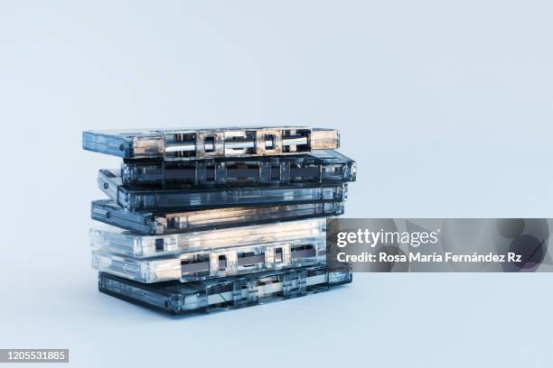 a stack of audio cassette tape on vintage style against grey background. - cassette fotografías e imágenes de stock