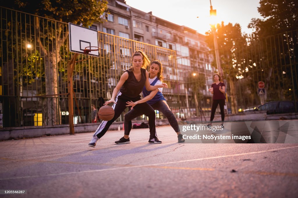 Girlfriends playing basketball