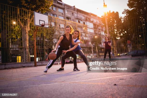 girlfriends playing basketball - street basketball imagens e fotografias de stock