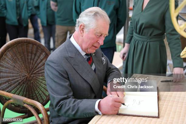 Prince Charles, Prince of Wales signs the visitors book during a visit to visit to Soane Britain Workshop, Britain’s last rattan workshop, Thurmaston...