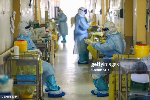 This photo taken on March 6, 2020 shows medical staff waiting outside rooms at the Red Cross hospital in Wuhan in China's central Hubei province. -...