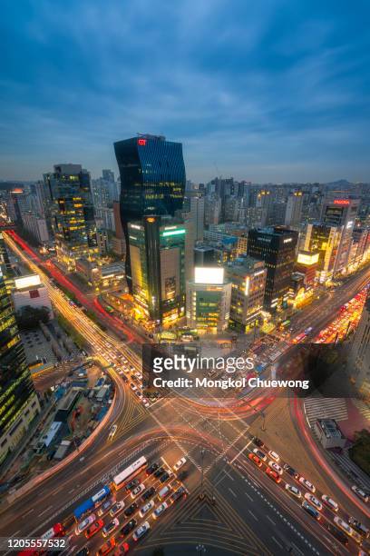 sunset scene of light trails traffic speeds through an intersection in gangnam center business district of seoul at seoul city, south korea. - south korea office stock pictures, royalty-free photos & images
