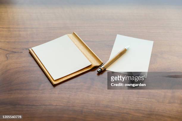 pen and post-it on wooden table - notepad table stock pictures, royalty-free photos & images