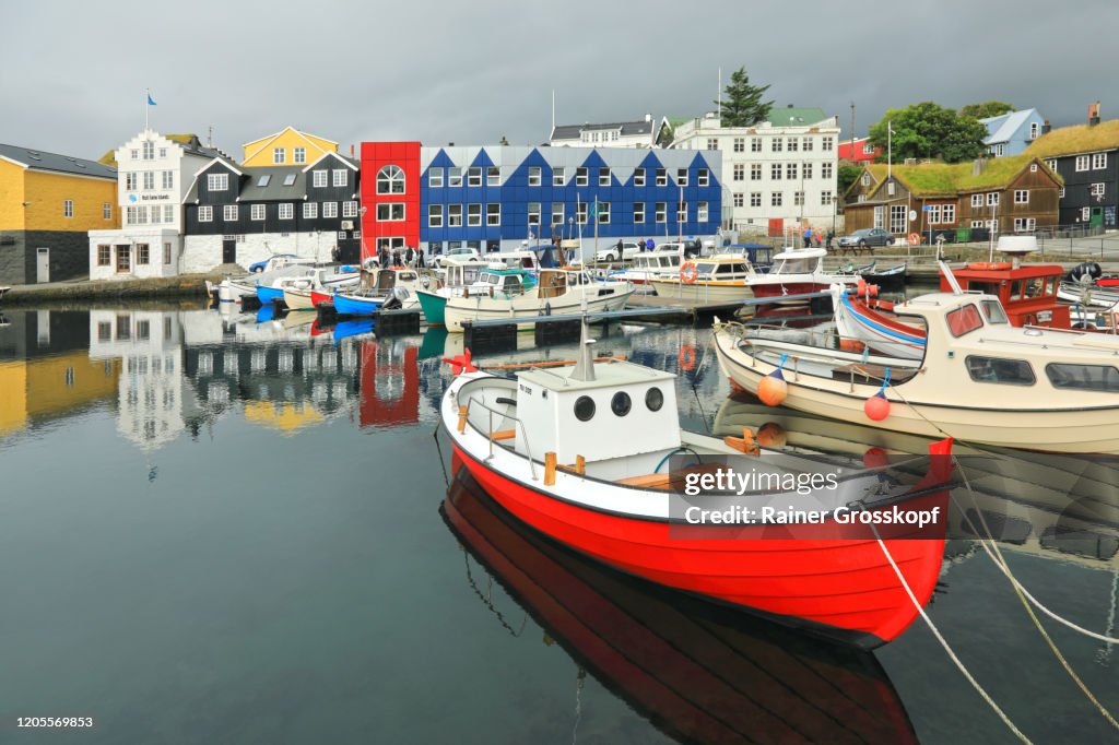 Colorful houses around a small fishing harbor with colorful boats
