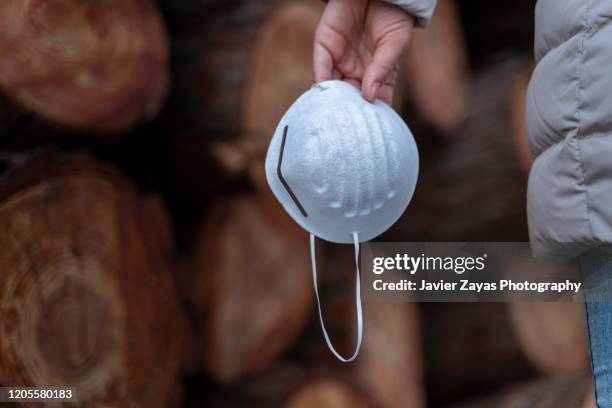 woman hand holding an allergy mask - máscara facial imagens e fotografias de stock