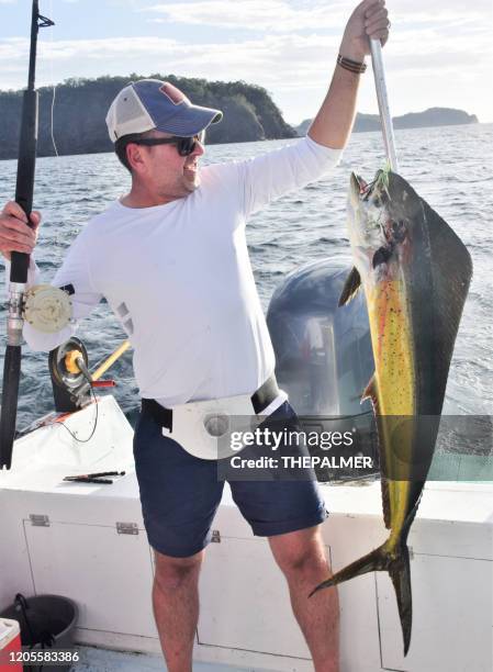 fisherman with dolphin fish in costa rica - deep sea fishing stock pictures, royalty-free photos & images