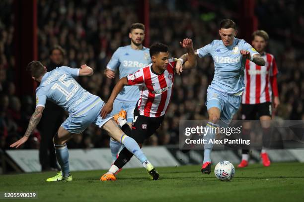 Ollie Watkins of Brentford is fouled by Stuart Dallas and Ben White of Leeds United during the Sky Bet Championship match between Brentford and Leeds...