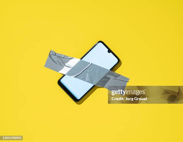 smartphone attached to a wall with duct tape - duct tape stock pictures, royalty-free photos & images
