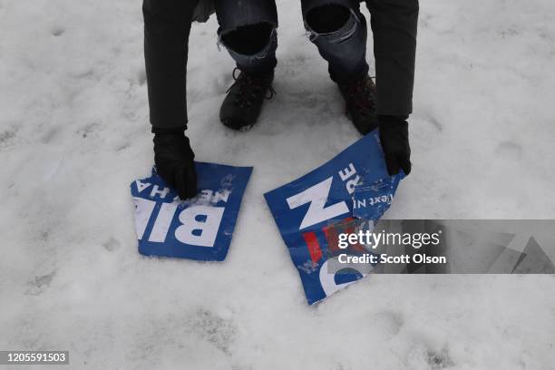 Supporter of Democratic presidential candidate former Vice President Joe Biden picks a campaign sign up off of the ground outside of a polling place...