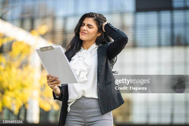 businesswoman with headache and problems - bankruptcy lawyer stock pictures, royalty-free photos & images