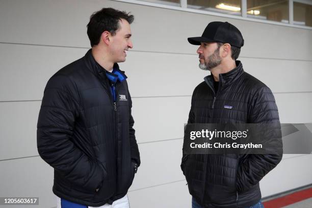 Graham Rahal, driver of the Rahal Letterman Lanigan Racing Honda, talks with NASCAR driver Jimmie Johnson during NTT IndyCar Series testing at...