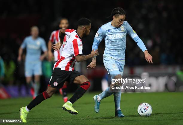 Helder Costa of Leeds United is challenged by Rico Henry of Brentford during the Sky Bet Championship match between Brentford and Leeds United at...