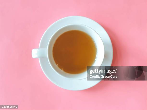 cup of tea with saucer on pink background - tazza da tè foto e immagini stock