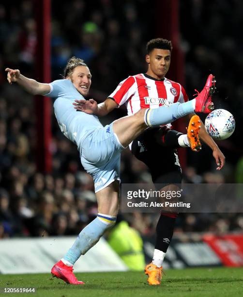 Luke Ayling of Leeds and Ollie Watkins of Brentford battle for the ball during the Sky Bet Championship match between Brentford and Leeds United at...