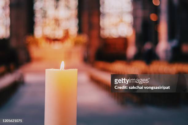 close-up of candle in the church - religion stock-fotos und bilder