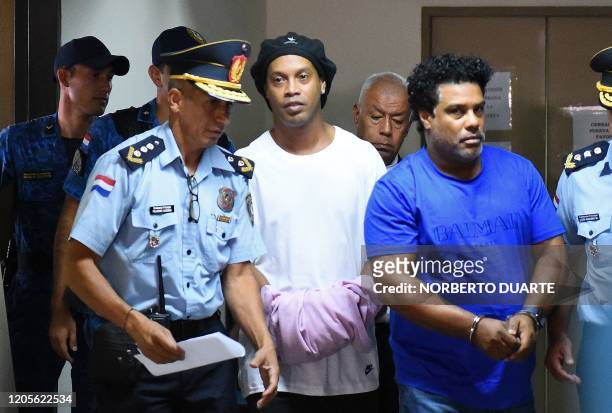 Brazilian retired football player Ronaldinho and his brother Roberto Assis arrive at Asuncion's Justice Palace to appear before a public prosecutor...
