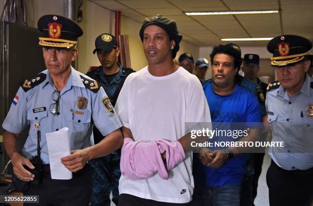 Brazilian retired football player Ronaldinho and his brother Roberto Assis arrive at Asuncion's Justice Palace to appear before a public prosecutor...