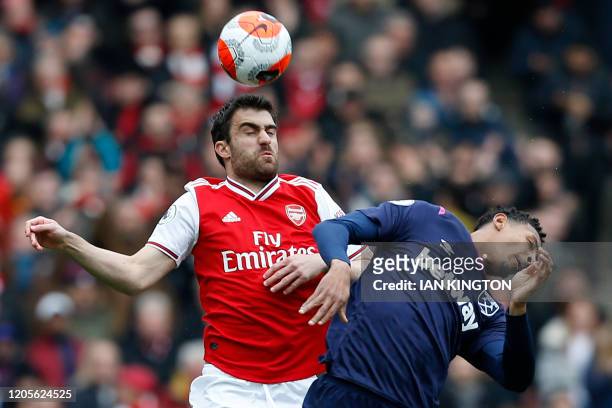 Arsenal's Greek defender Sokratis Papastathopoulos vies with West Ham United's French striker Sebastien Haller during the English Premier League...