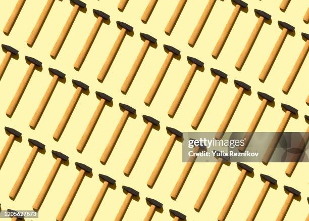 repeated old hammer on the yellow background - hand tool stock pictures, royalty-free photos & images