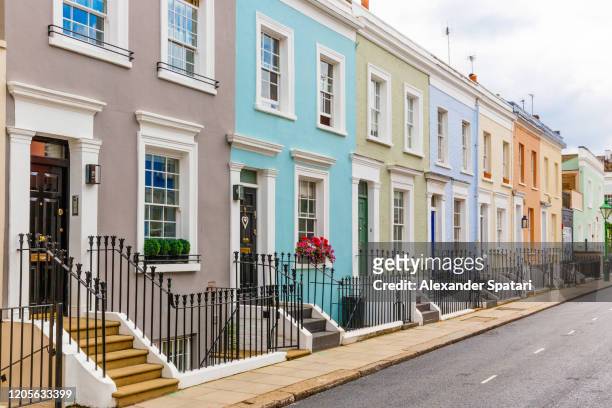 street in residential district with row houses in london, uk - uk stock-fotos und bilder