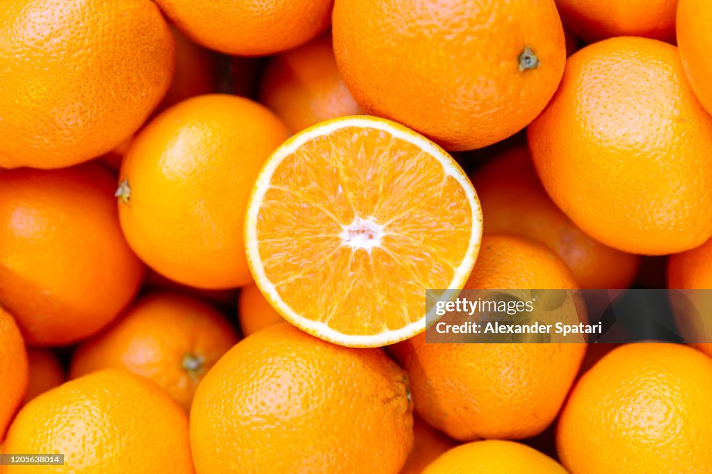 Half of orange on the heap of oranges