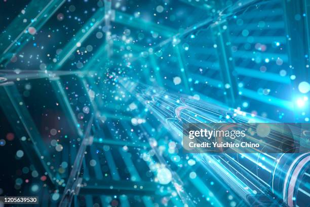 abstract mechanical tunnel and glowing particle - quantum computer photos et images de collection