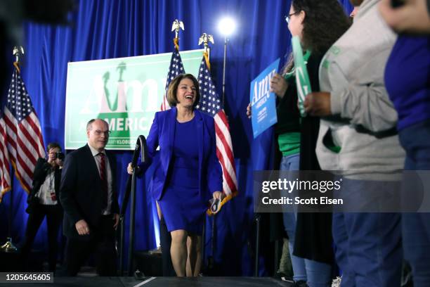 Democratic presidential candidate Sen. Amy Klobuchar takes the stage with spouse John Bessler during a primary night event at the Grappone Conference...