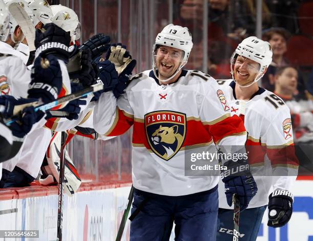 Mark Pysyk of the Florida Panthers celebrates his goal with teammates on the bench as Mike Matheson joins in the second period against the New Jersey...