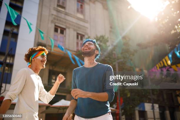 gay couple dancing at brazilian carnival - street party stock pictures, royalty-free photos & images