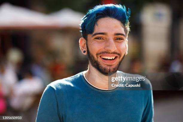 portrait of young smiling man with blue hair - dyed hair stock pictures, royalty-free photos & images