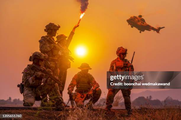 silhouette soldiers on the sunset sky background - military rescue stock pictures, royalty-free photos & images