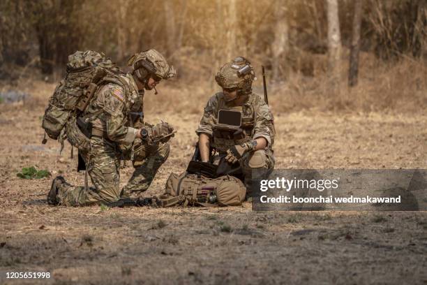 soldiers in special forces, army soldier in protective combat uniform holding special operations forces combat assault rifle. - sunglasses disguise imagens e fotografias de stock