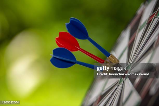 dart arrow hitting in the target center of dartboard. concept of the success - archery target stock pictures, royalty-free photos & images