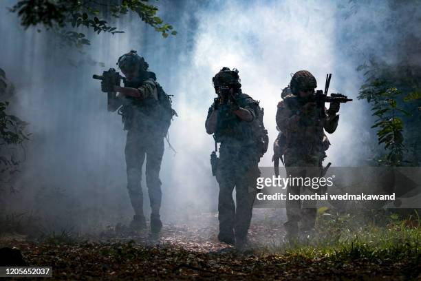 battle of the military in the war. military troops in the smoke - terrorism stock pictures, royalty-free photos & images