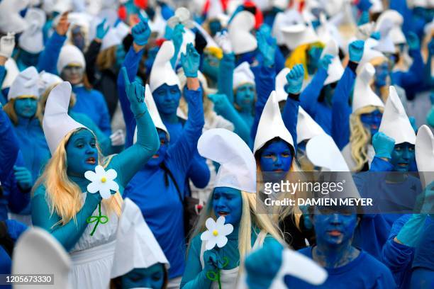 People dressed as Smurfs , a Belgian comic franchise centered on a fictional colony of small, blue, human-like creatures who live in mushroom-shaped...