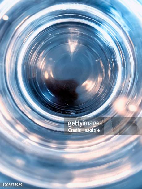 the abstract pattern of looking down on a glass of water - blue water ripple overhead stock pictures, royalty-free photos & images