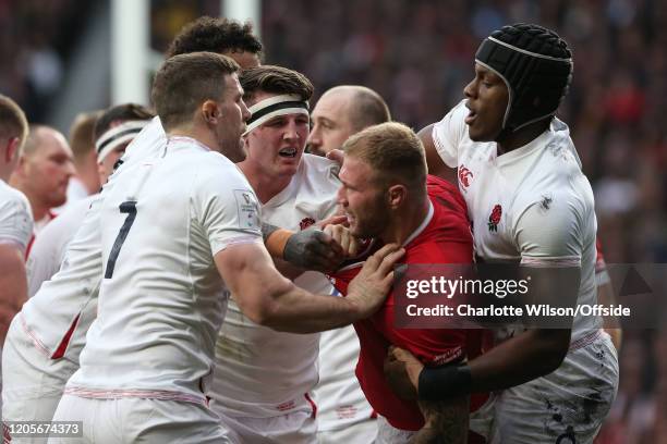 Tom Curry of England fights with Ross Moriarty of Wales during the 2020 Guinness Six Nations match between England and Wales at Twickenham Stadium on...