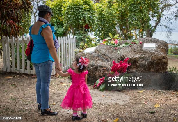Woman and a girl visit the grave of Nicaraguan late poet Ernesto Cardenal in Solentiname, Rio San Juan, Nicaragua, on March 7, 2020. - Cardenal,...