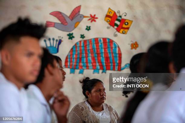 Woman attends a mass in honour of Nicaraguan late poet Ernesto Cardenal in Solentiname, Rio San Juan, Nicaragua, on March 7, 2020. - Cardenal, figure...