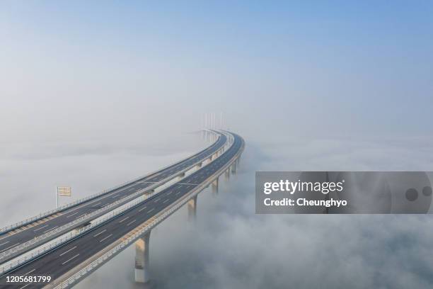 drone aerial view of the jiaozhou bay bridge of qingdao,shandong,china - viaduct stock-fotos und bilder