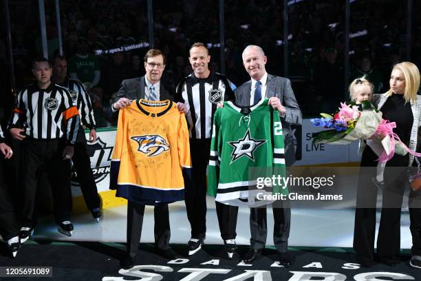Referee Gord Dwyer is presented with a team signed jersey from Nashville Predators President of Hockey Operations David Poile and Dallas Stars...