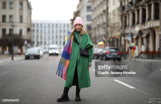 Sonia Lyson wearing The Frankie Shop sweater, Zara coat, boots and scarf, Prada bag, Anine Bing leather pants and Acne Studios hat on February 11,...