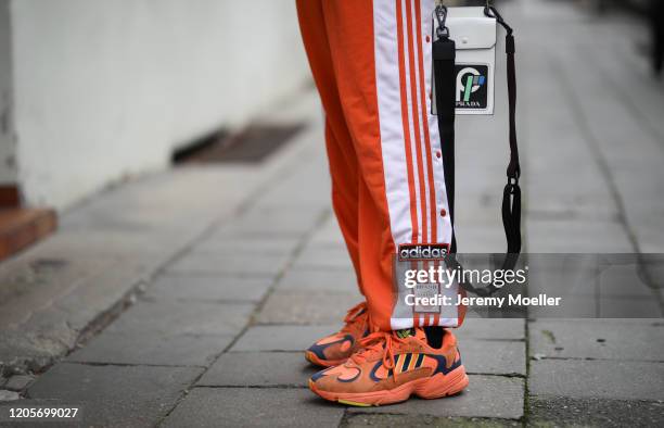 Erik Scholz wearing Adidas trackpants and sneaker, Prada bag, Balenciaga sweater and Daily Paper puffer jacket on February 11, 2020 in Berlin,...