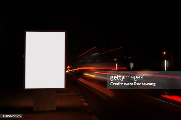 billboard illuminated light boxes advertising at night - billboard night photos et images de collection