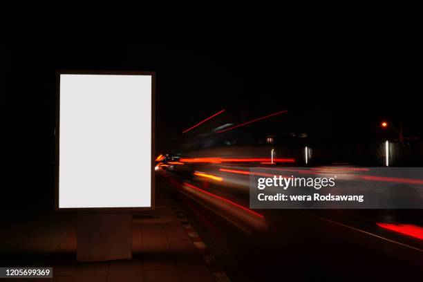 billboard illuminated light boxes advertising at night - city light poster stock pictures, royalty-free photos & images