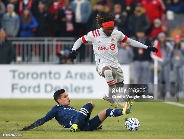 Ifunanyanchi Achara of Toronto FC dribbles the ball as Ronald Matarrita of New York City FC defends during the first half of an MLS game at BMO Field...