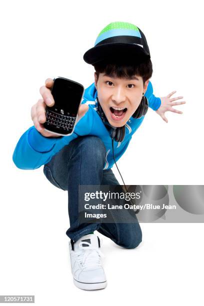 excited man showing his phone - hip hop music stock pictures, royalty-free photos & images
