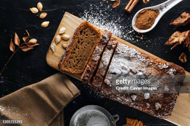 pumpkin sponge cake cut into slices with powdered sugar on top - banana loaf stock pictures, royalty-free photos & images