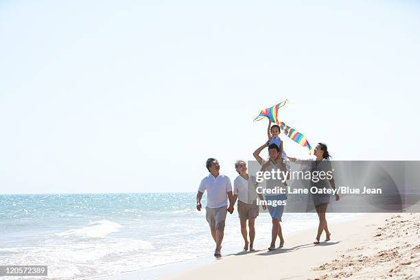 family playing at the beach - girls in wet dresses stock-fotos und bilder